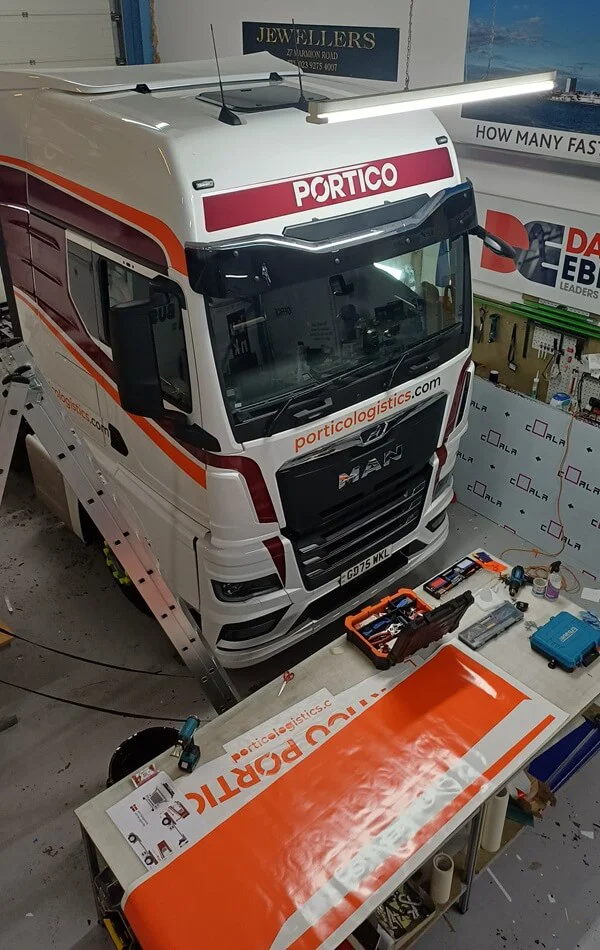 An image of the Portico Logistics bus getttng a vehicle wrap.